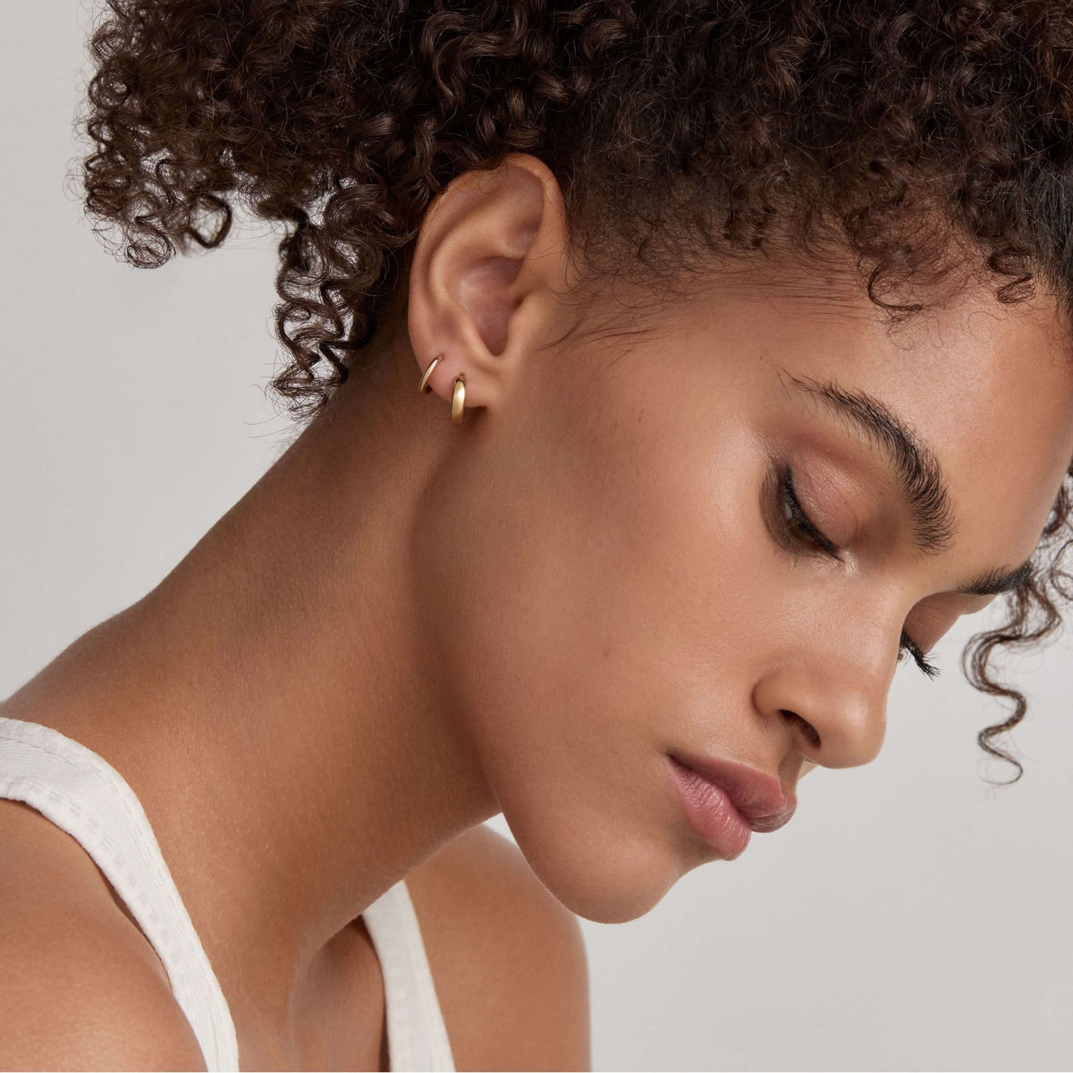 Classic Huggie Hoops, 11mm and Bold Huggie Hoops, 12mm on Model - Gold