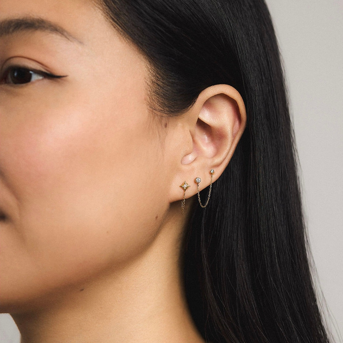 North Star Chain and Celestial Crystal Solitaire Duo Chain Nap Earrings - Gold (On Model)