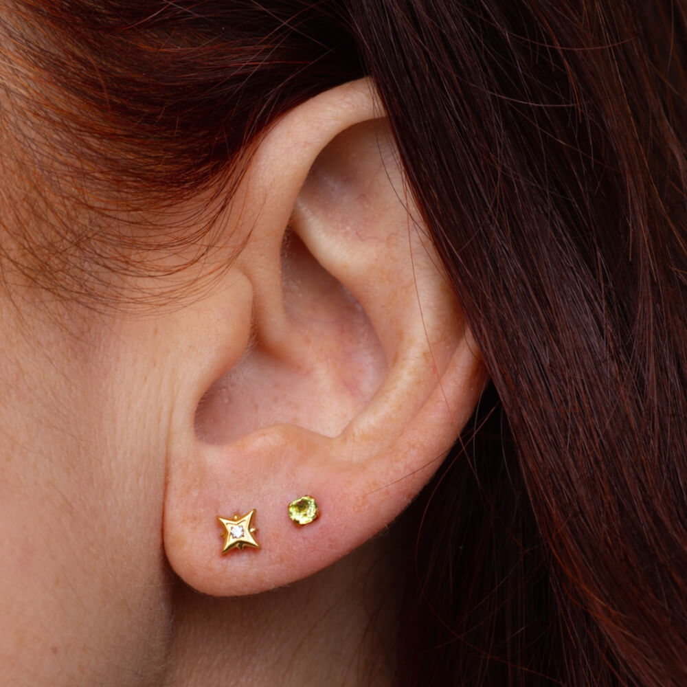 North Star and Peridot Nap Earrings (Gold) on model
