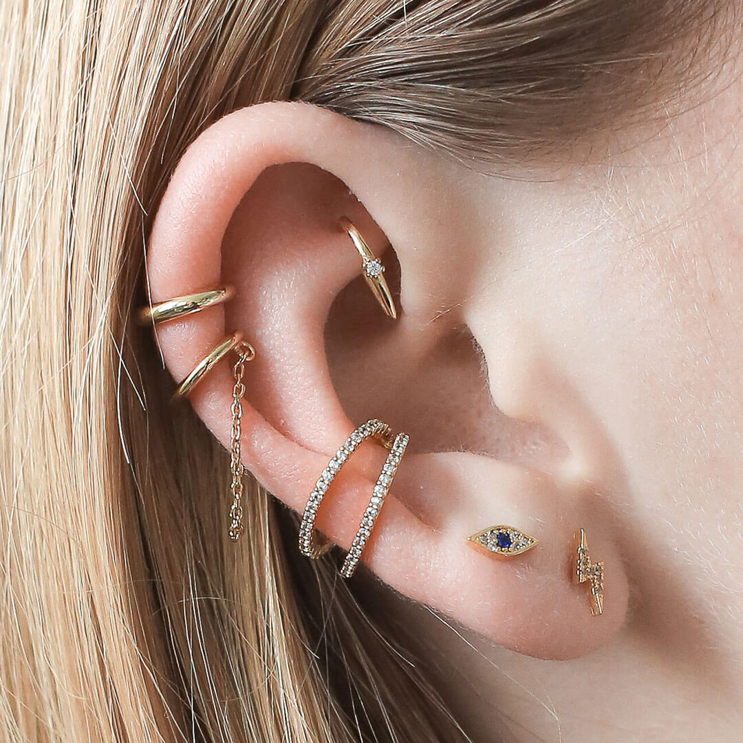 Ear stack featuring lightning, evil eye, and shooting star jewelry