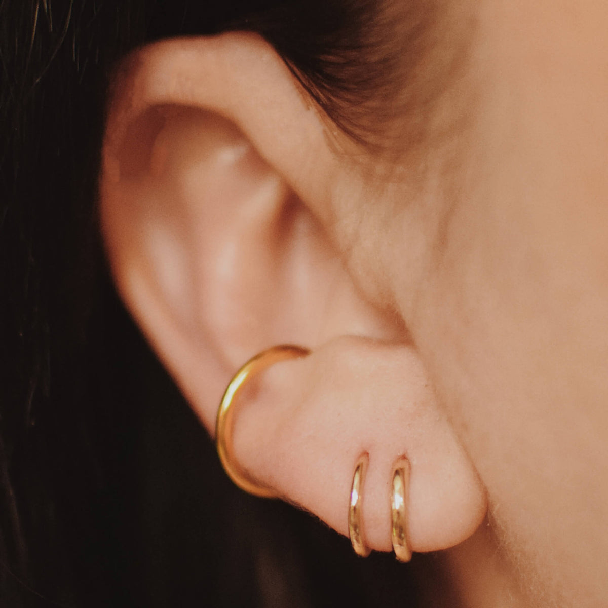 Classic Huggie Hoops in 14k Gold on model