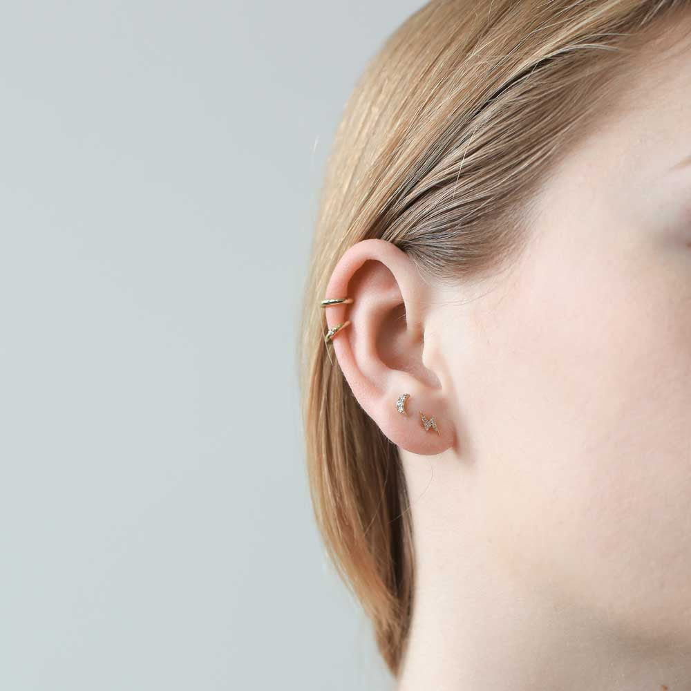 Classic Cartilage Hoop, Shooting Star Open Hoops and Pave Moon and Lightning Studs in 14k Gold on model