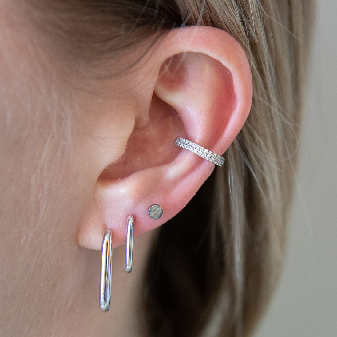 Halo Oval Hoops, 15mm and Bolt Push Pin Flat Back Earring on model (Titanium - Silver)