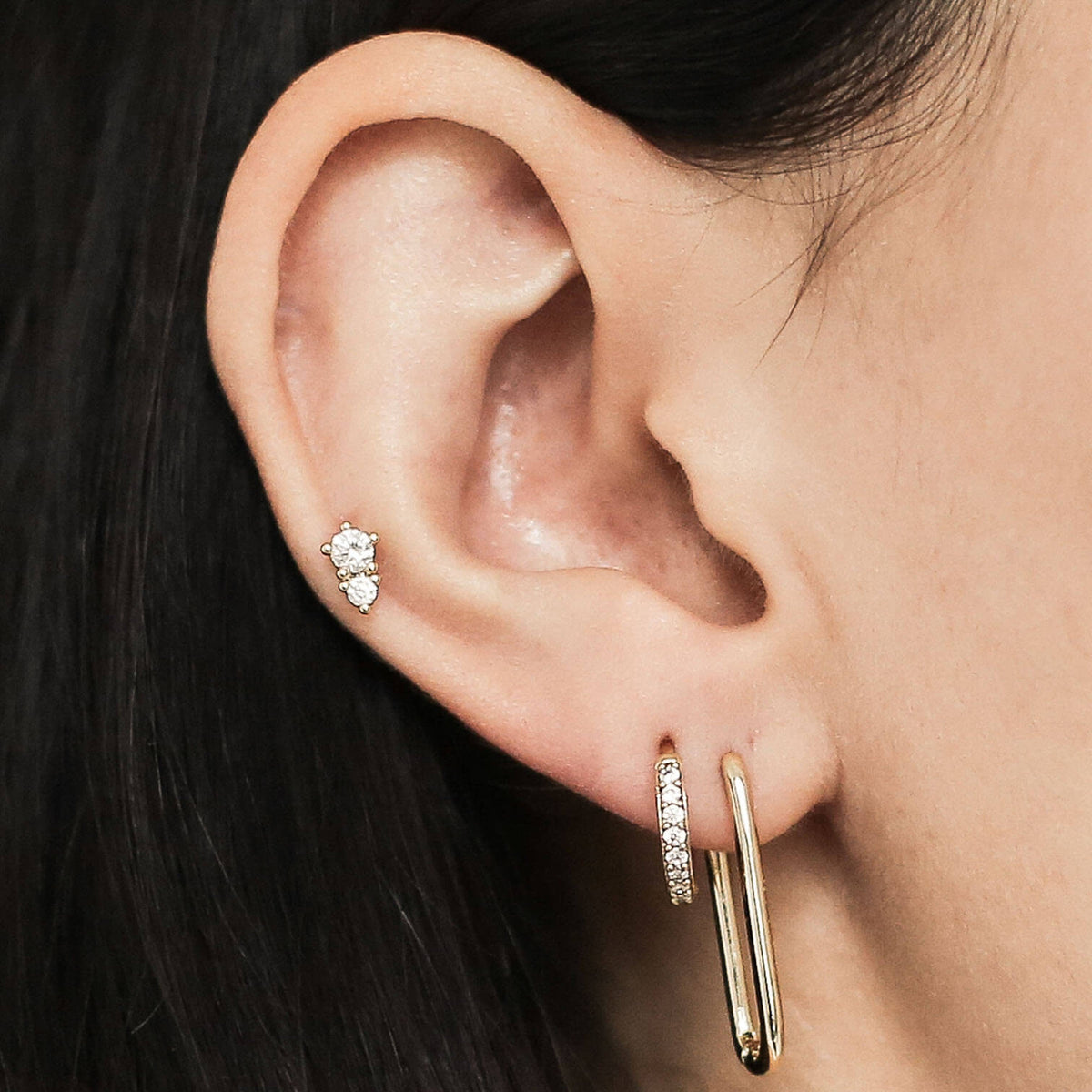 Pave Huggie Hoop, 11mm, Halo Oval Hoops, 23mm and Gaia Threaded Flat Back Earring (Titanium - Gold) on model