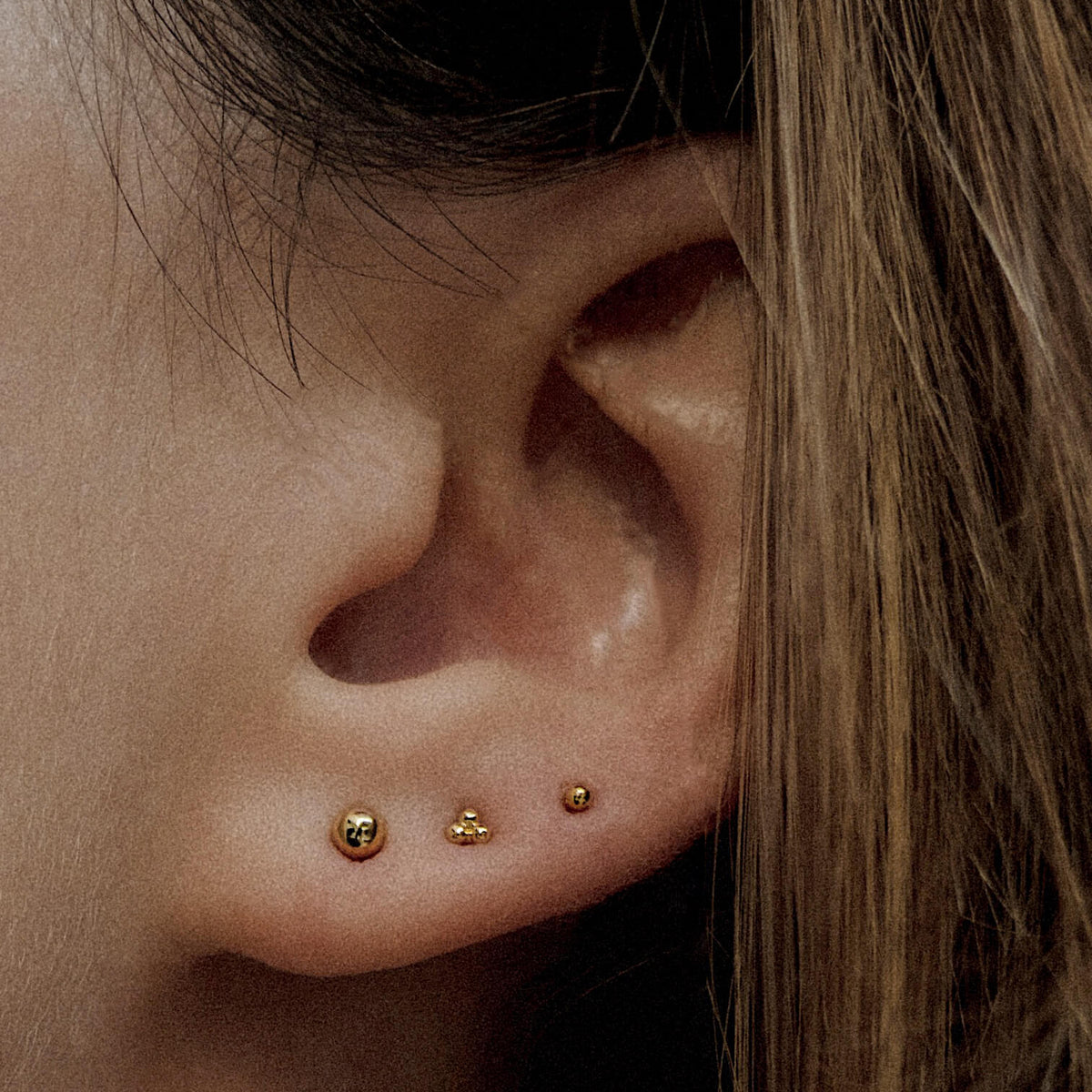 Little Sphere Push Pin Flat Back Earring and Trinity Ball Back Earrings in 14k Gold on model