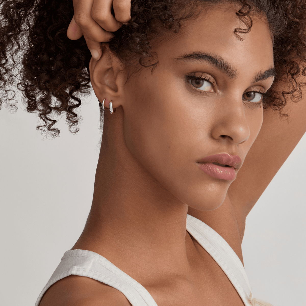 Classic Huggie Hoops, 11mm and Bold Huggie Hoops, 12mm on Model - Silver