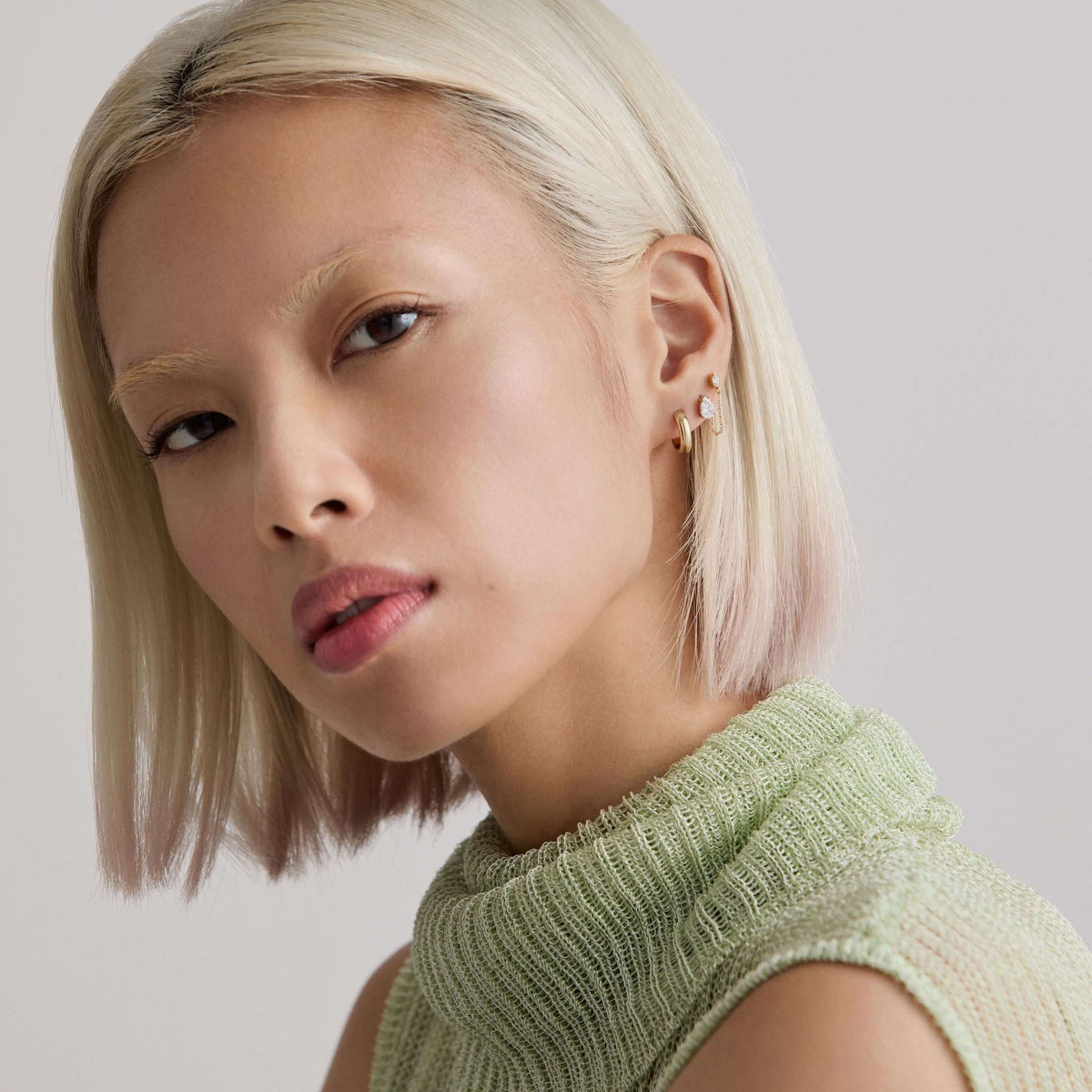 Model wearing a curated stack of MIRU earrings