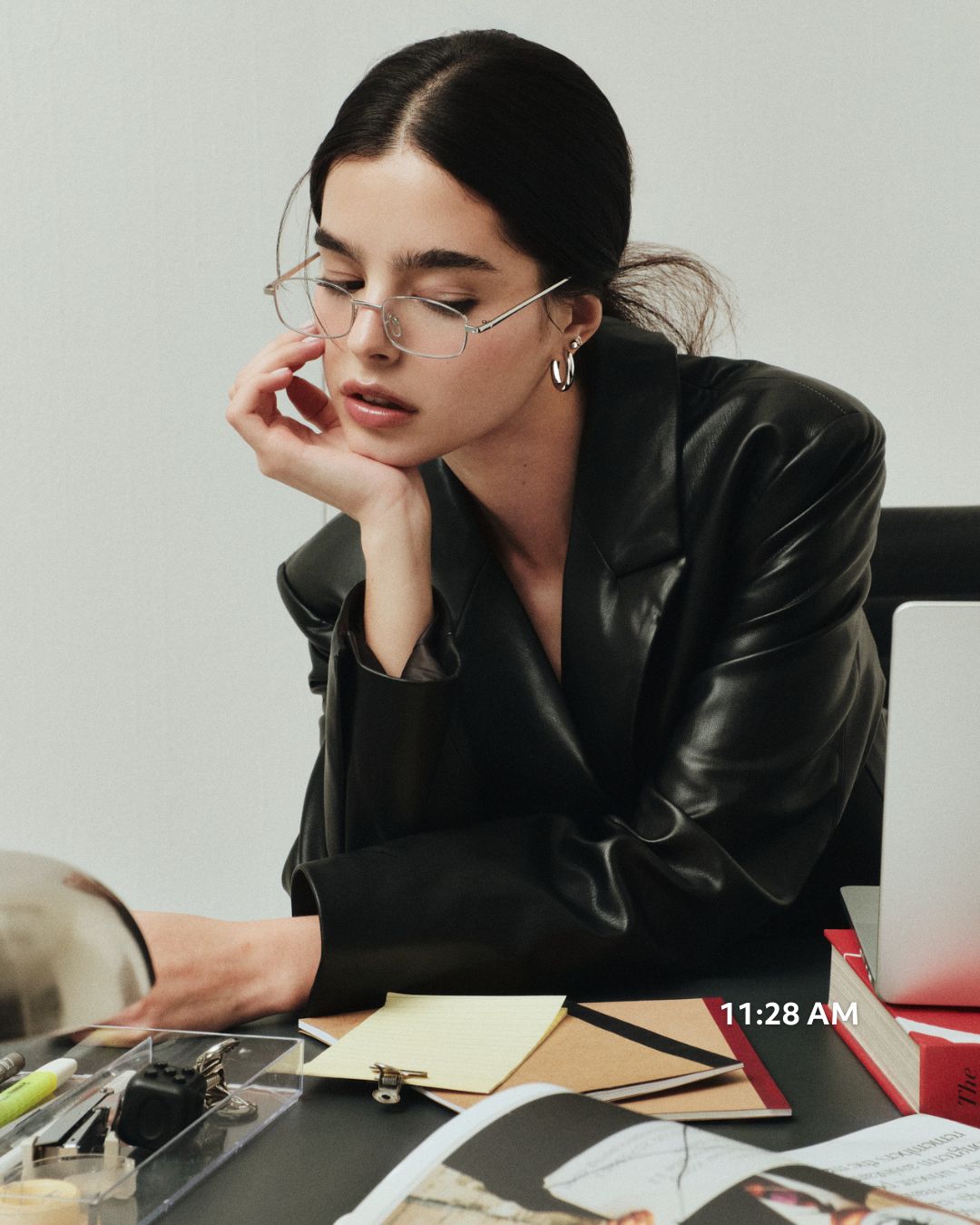Model wearing Every Body Hoops in silver at a desk