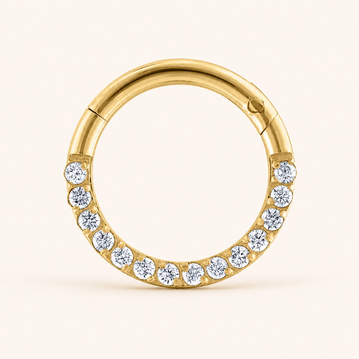 Gold crystal clicker cartilage hoop with its hinge and closure seam visible