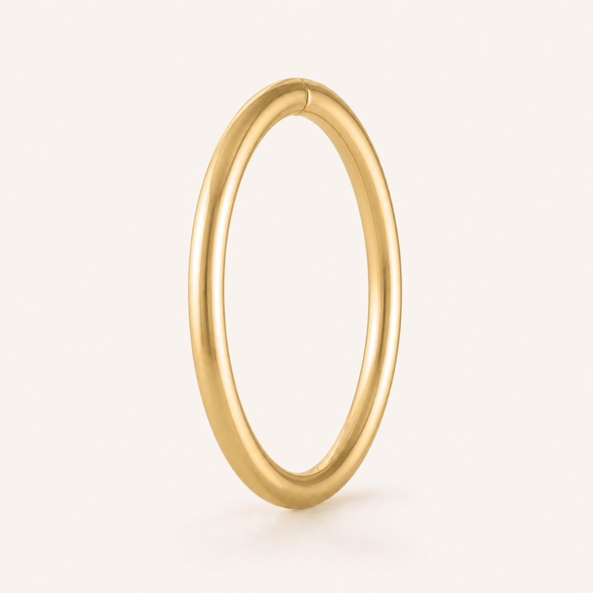 Closed gold seamless hoop with a subtle seam