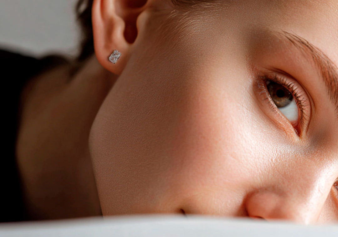Close-up of a person's ear wearing Nap Earrings against a neutral background