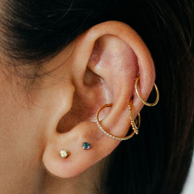 Classic, Siren and Eternity Cartilage Hoop and Moissanite, 3mm and Blue Topaz Nap Earrings (Gold) on model