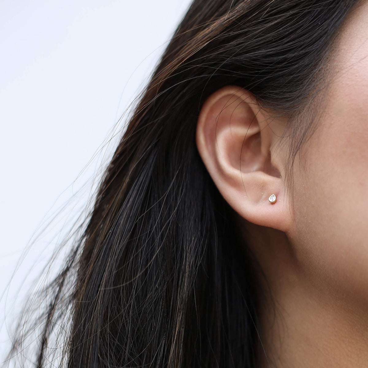 Celestial Crystal Pear Bezel Solitaire Threaded Flat Back Earring (Titanium - Gold) on model
