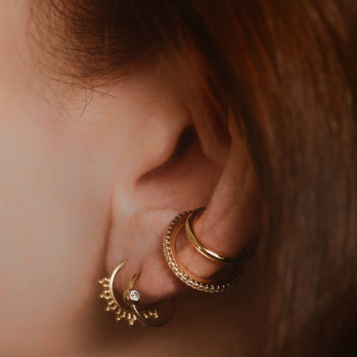 Siren and Orbital Crystal Cartilage Hoop on model (Titanium - Gold)