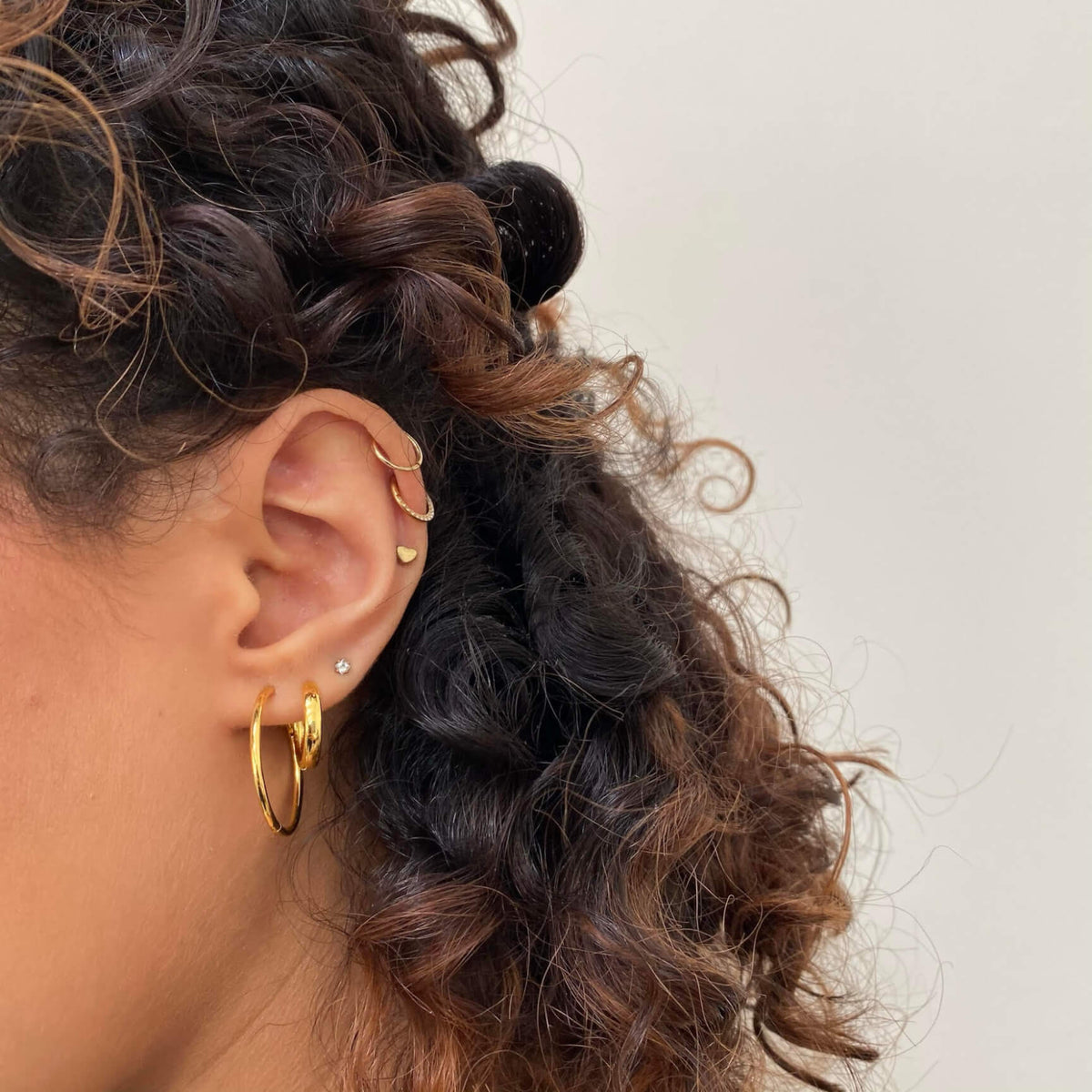 Classic Hoops, 25mm, Bold Hoops, 14mm, Celestial Crystal Solitaire and Heart Push Pin Flat Back earring, Classic and Cosmic Cartilage Hoop (Titanium - Gold) on model